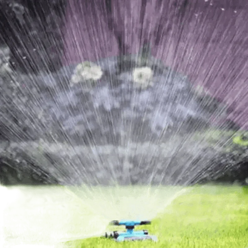 Blue Rotating Garden Sprinklers Watering Grass